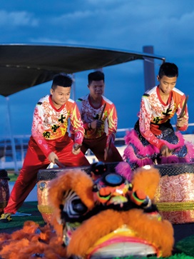 Traditional dancers beating a drum in Asia
