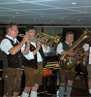 Three men playing brass instruments in a Bavarian Band