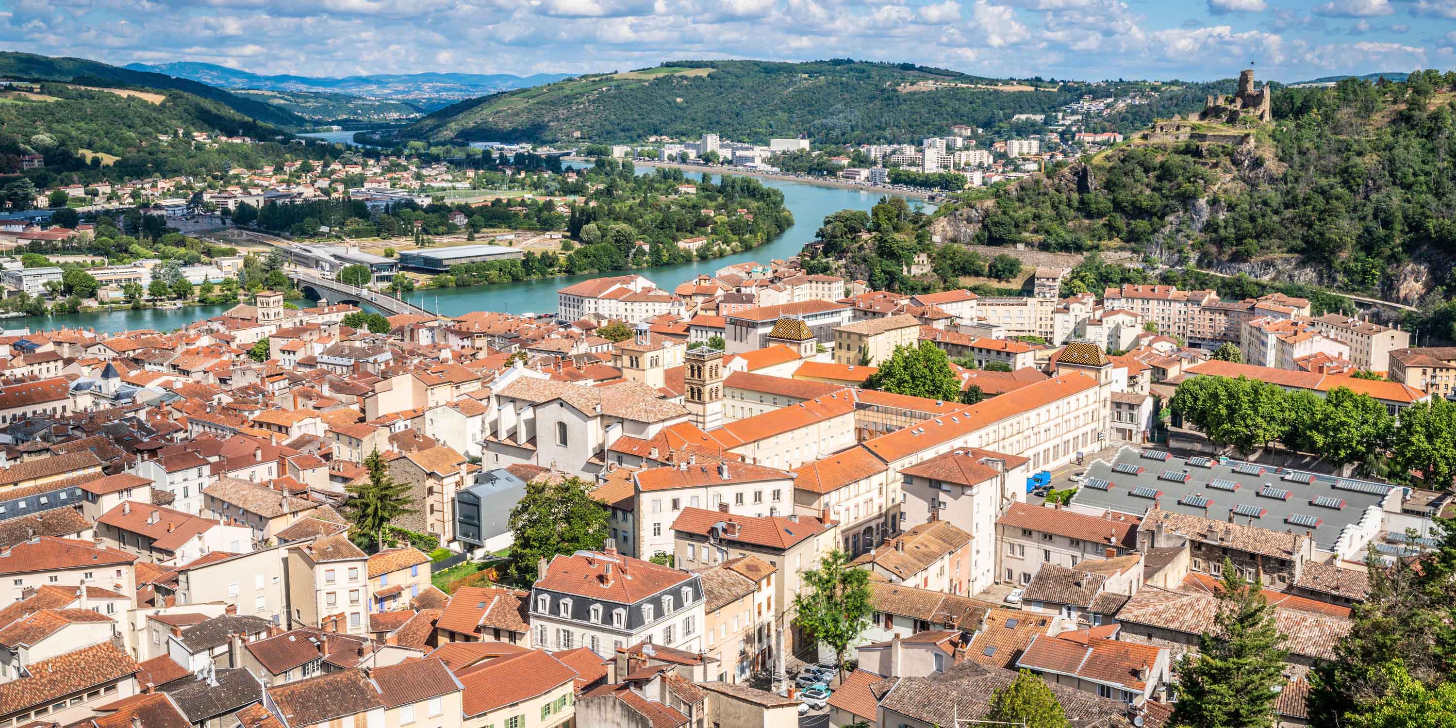 Overlooking the city of Vienne Isere in France with red roofs and a river