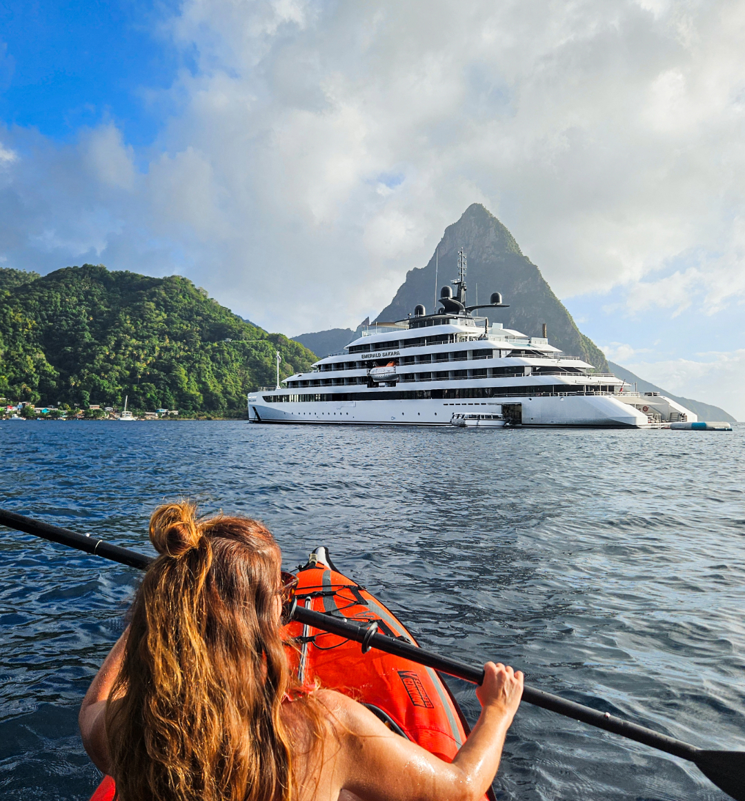 Woman kayaking in front of Emerald yacht cruise