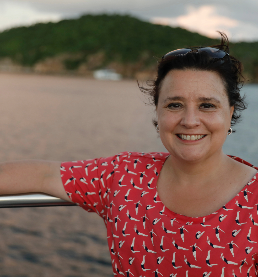 Susan Calman leaning against yacht deck railings in the caribbean