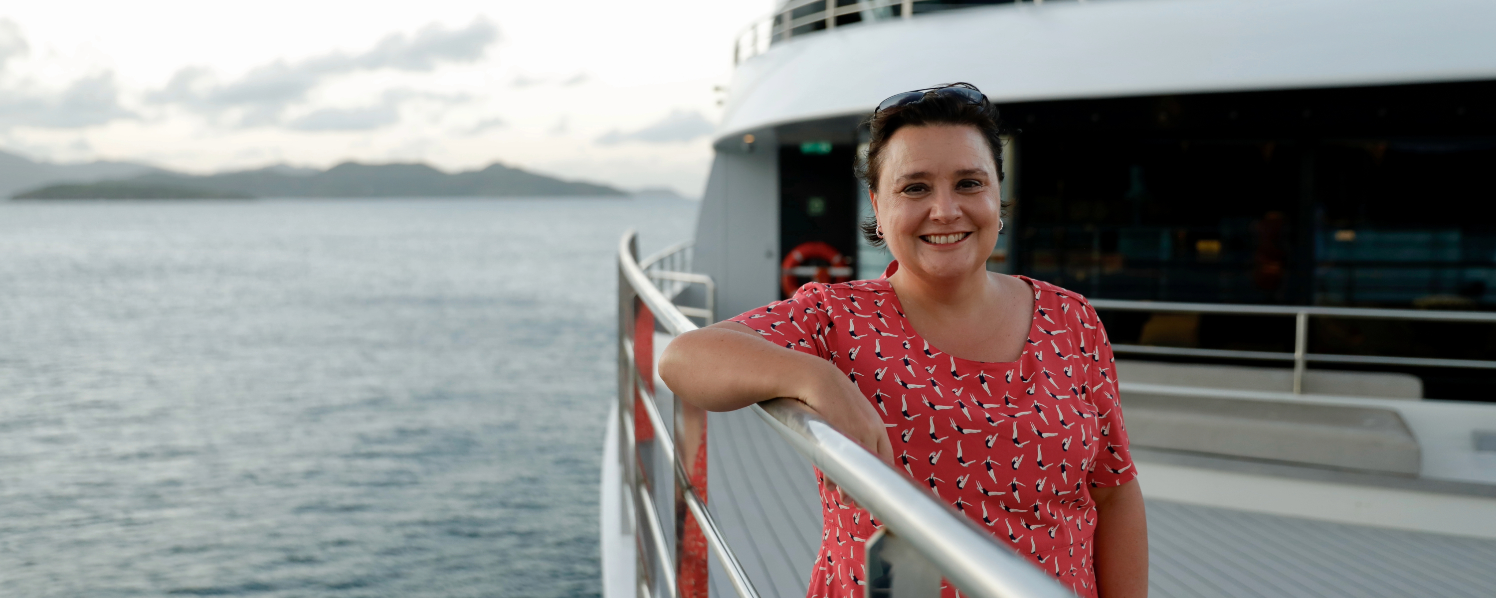 Susan Calman in the caribbean leaning against yacht railings
