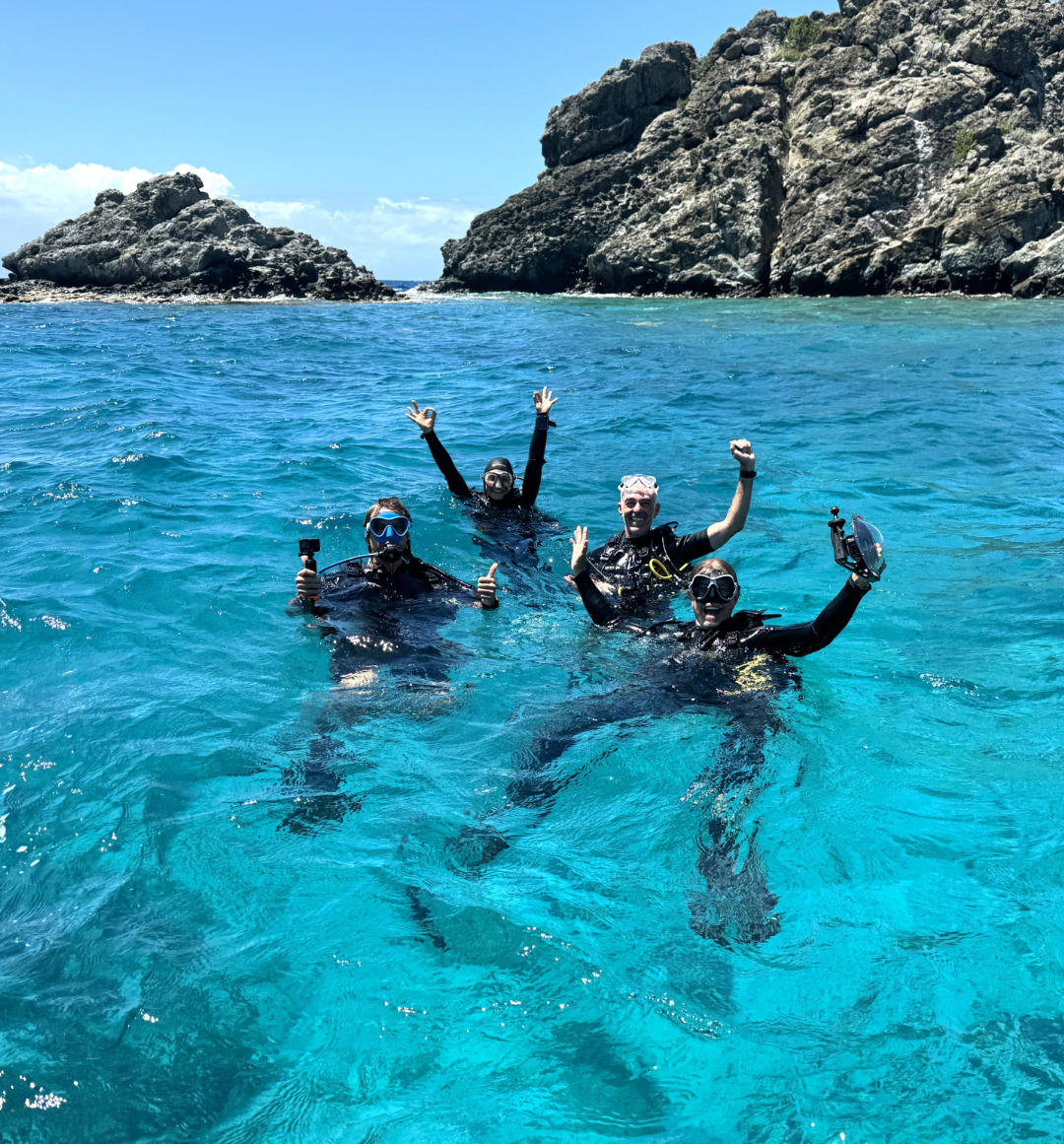 Emerald yacht guests snorkeling in blue Caribbean water