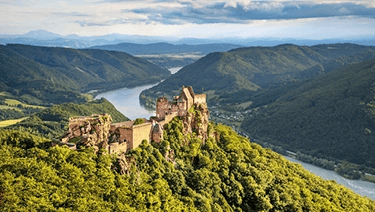 Durnstein Castle atop of a green hill in the Wachau Valley of Austria, near the banks of the Danube River