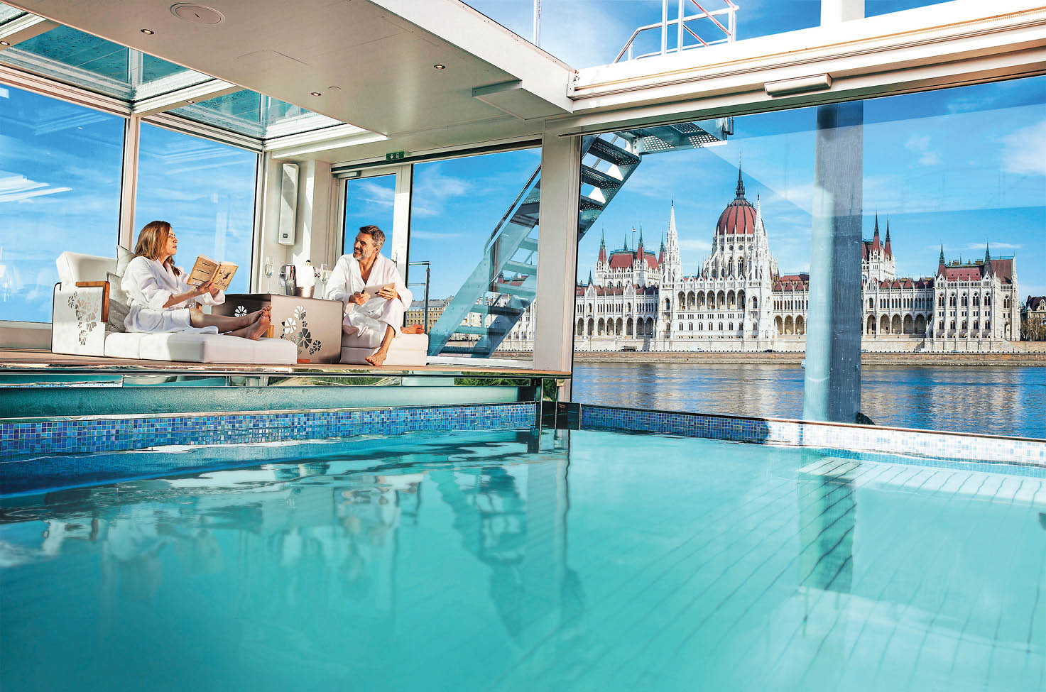 Couple relaxing by the pool on board a luxury river ship in Budapest, Hungary