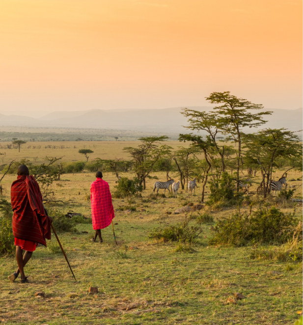 Two members of the Maasai walking through the bush in Kenya.