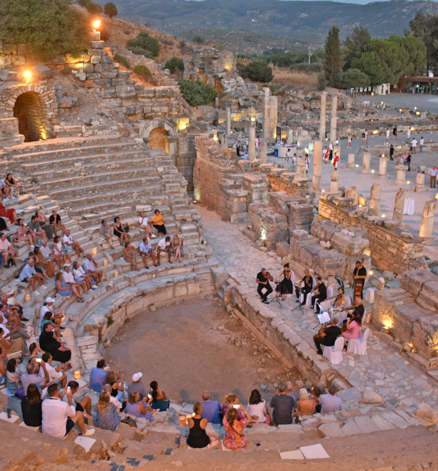 A classical concert in the ancient theatre of Ephesus in Turkey, showcasing its grand architecture and historical significance.