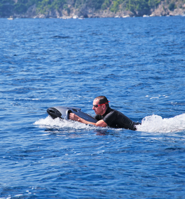 A man poweing through the ocean waters using a seabob.