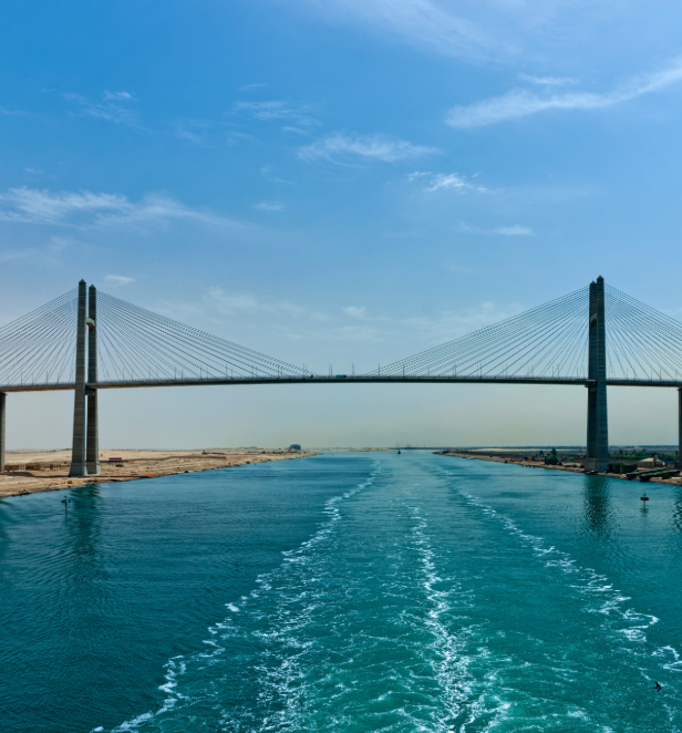 The Suez Canal bridge, Egypt shown amongst clear blue skies and serene waters. 
