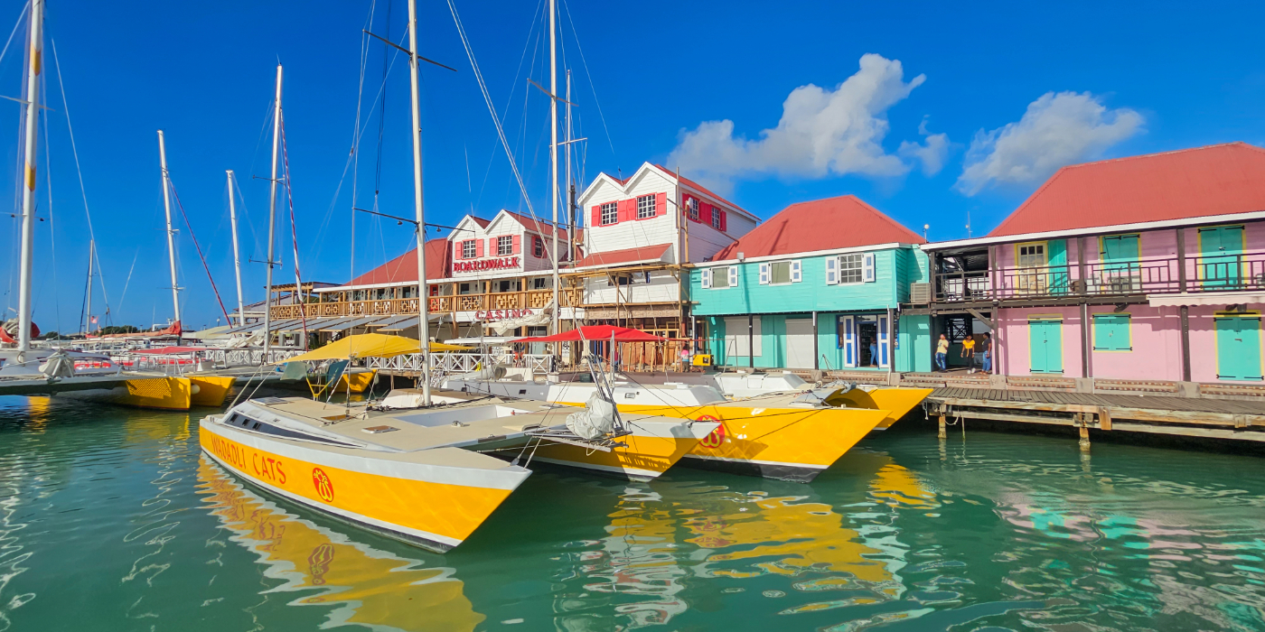 Brightly coloured boats can be seen floating in a marina