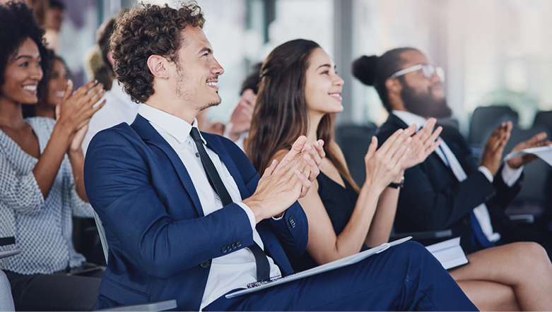 Group of people wearing business attire clapping