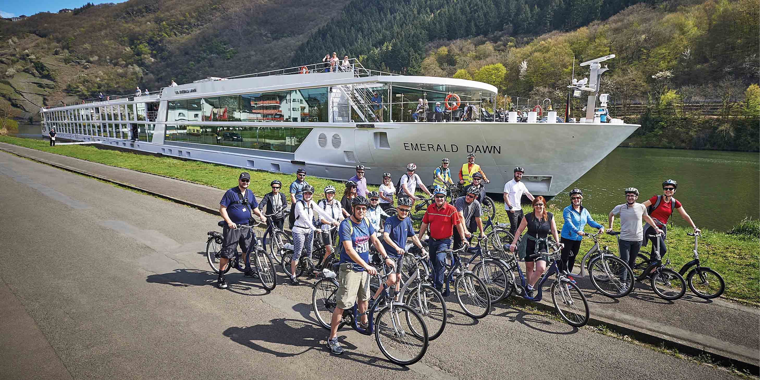 Group of people on bikes in front of a luxury river cruise ship