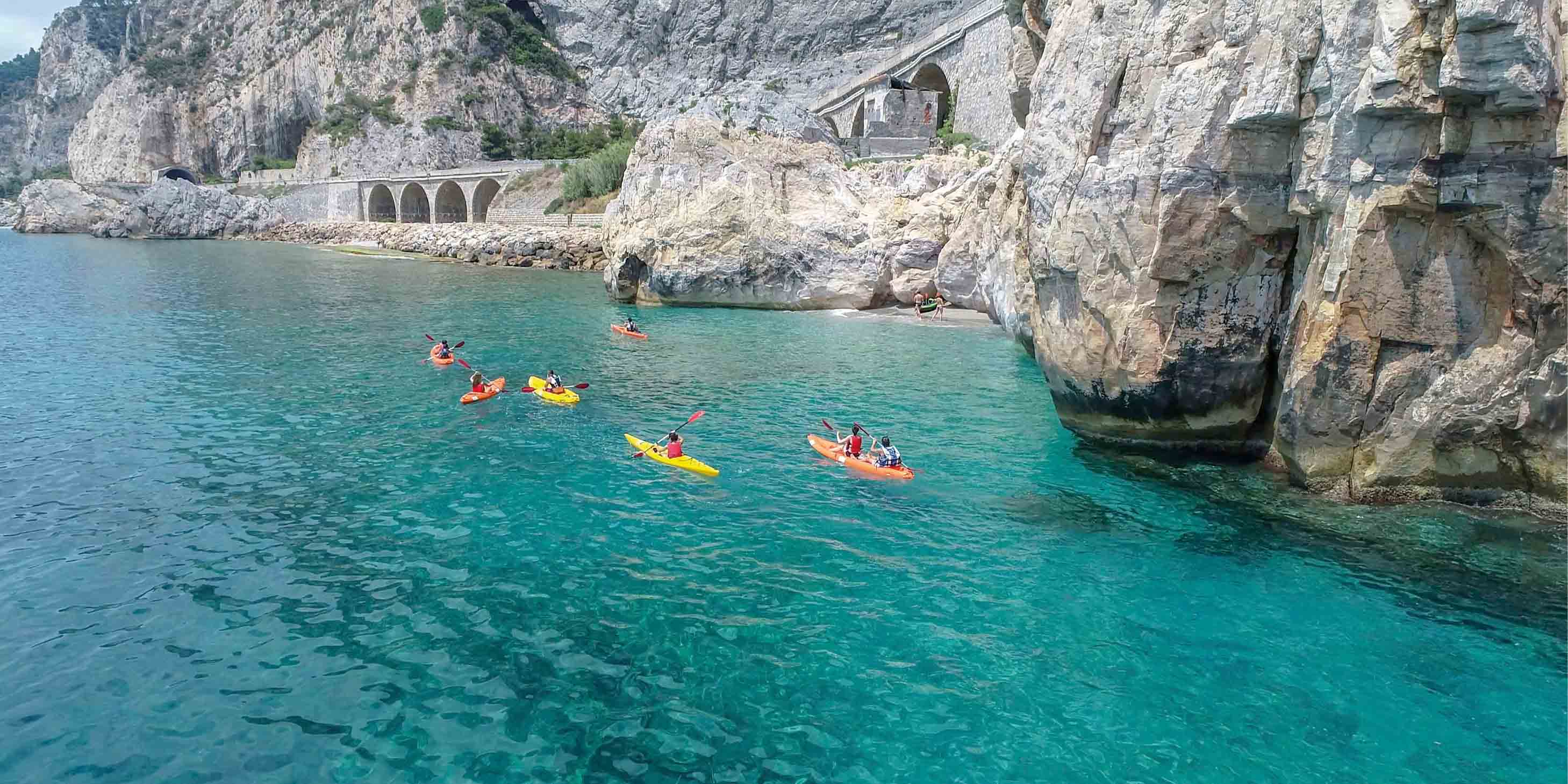 Group of people sea kayaking in crystal blue water
