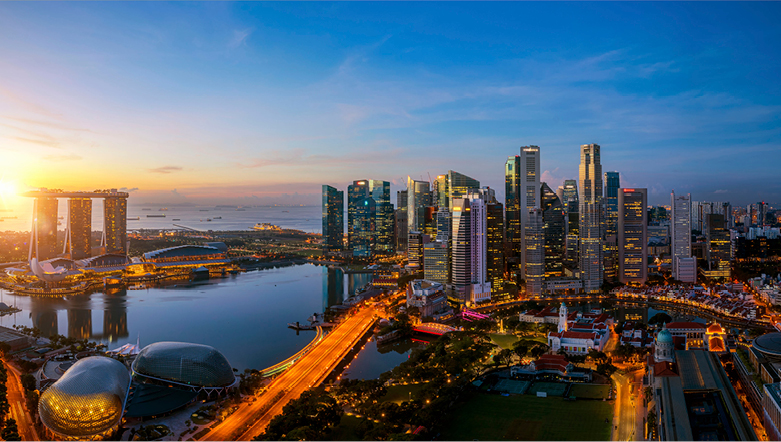  Singapore skyline at sunrise, with high-rise buildings and the streets below with an orange glow