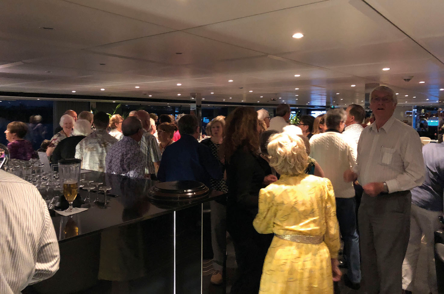 A room full of people who are dressed smartly and enjoying themselves