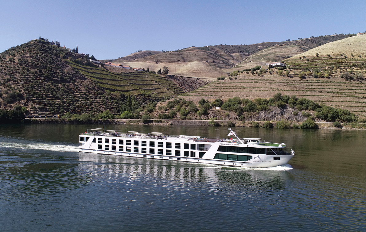 Emerald Radiance river cruise ship sailing the Douro River through the rolling hills of the Douro Valley in the sunshine