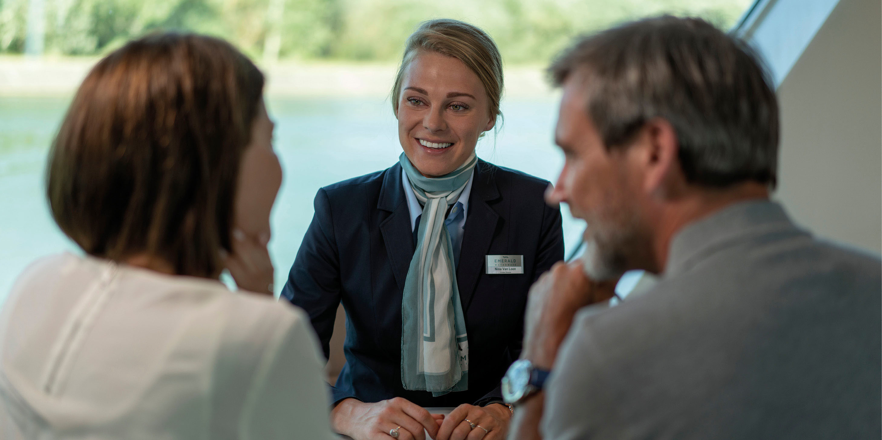 Cruise director helping guests on board a luxury river ship in Europe