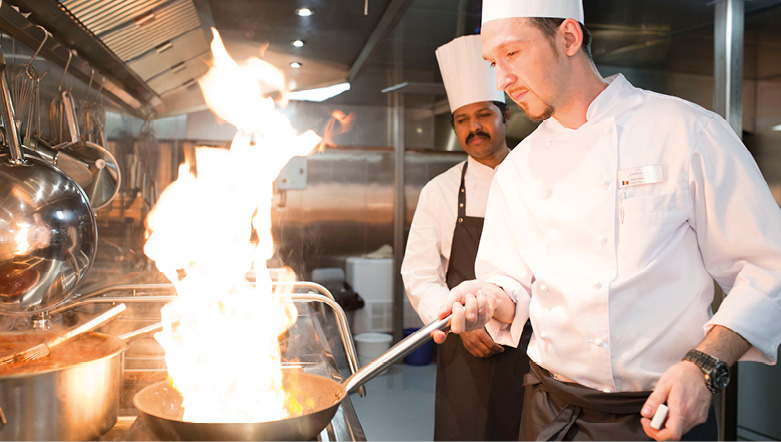 Two chefs preparing a delicious meal for guests on board a luxury river ship in Europe