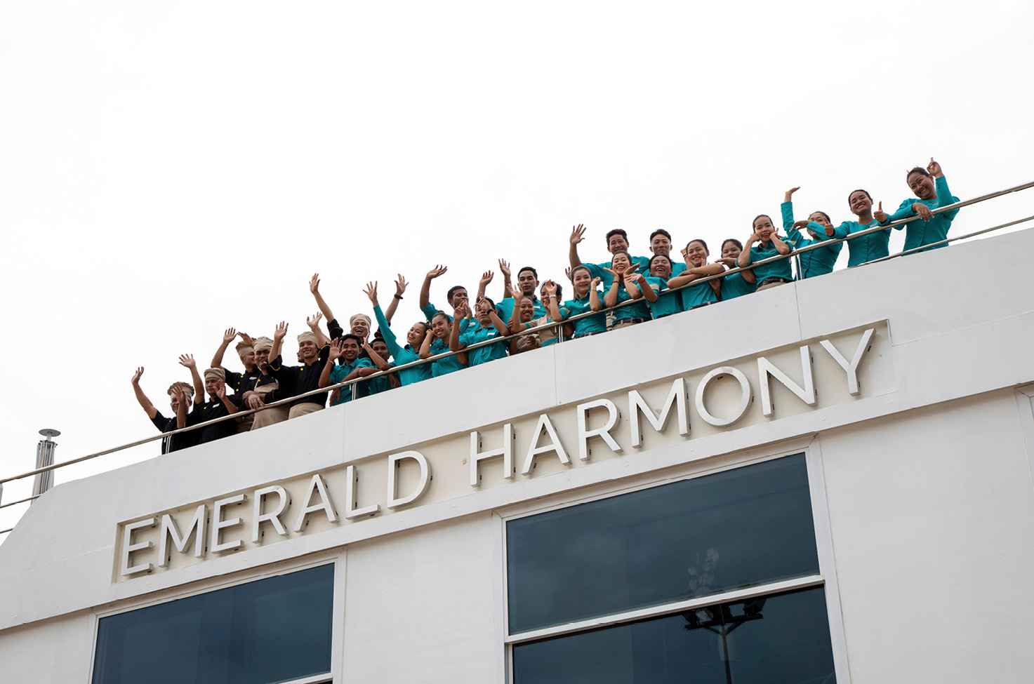 The crew on board Emerald Harmony, a luxury river cruise ship sailing Southeast Asia