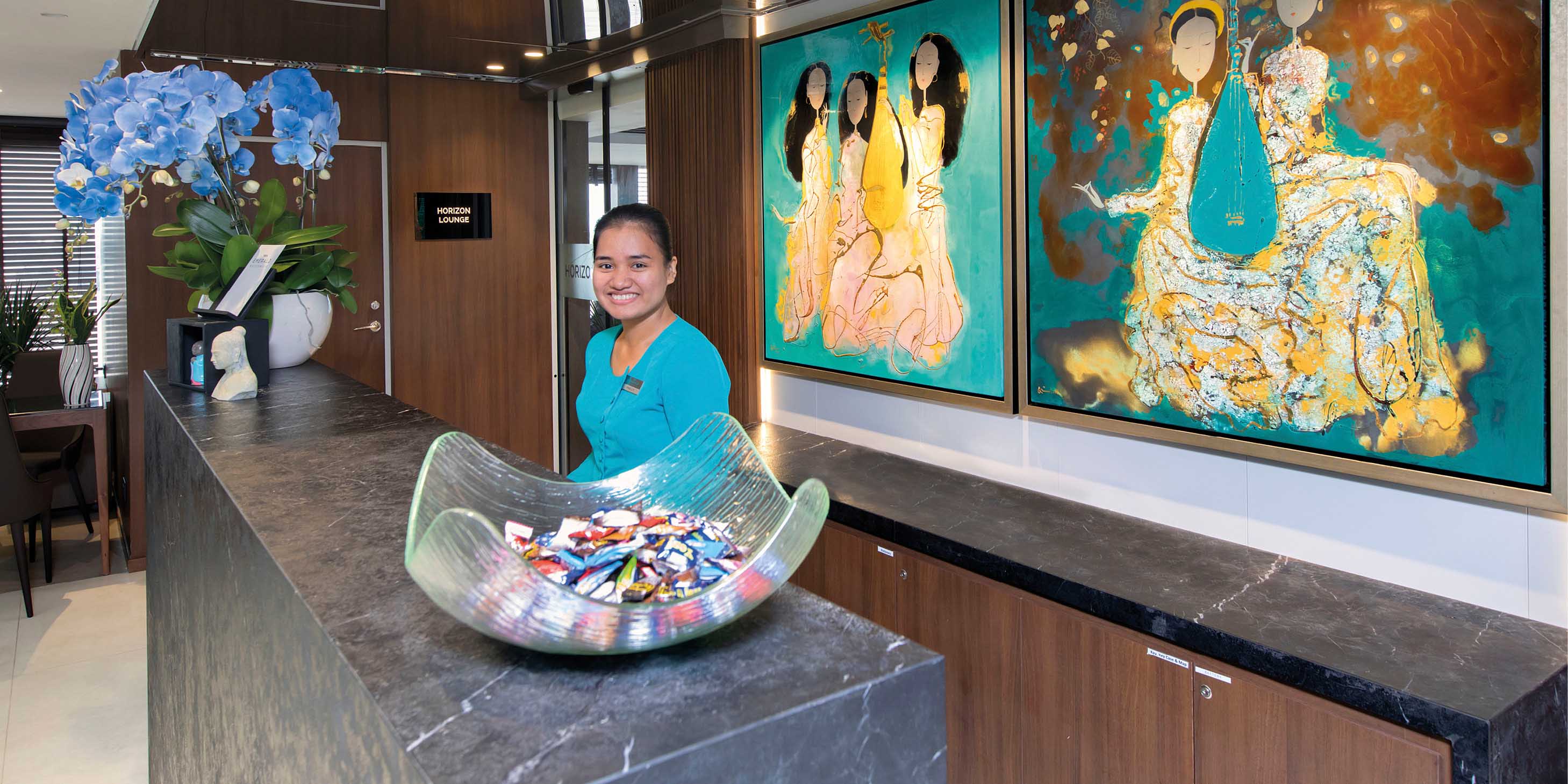 Team member at the Reception area on board a luxury river ship in Southeast Asia