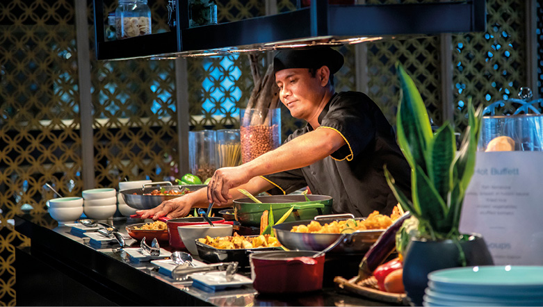 Chef serving up delicious Asian inspired food on board a luxury river ship in Southeast Asia