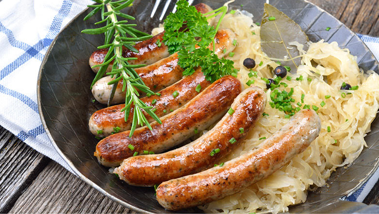 Authentic bratwurst sausages on a plate with potato.