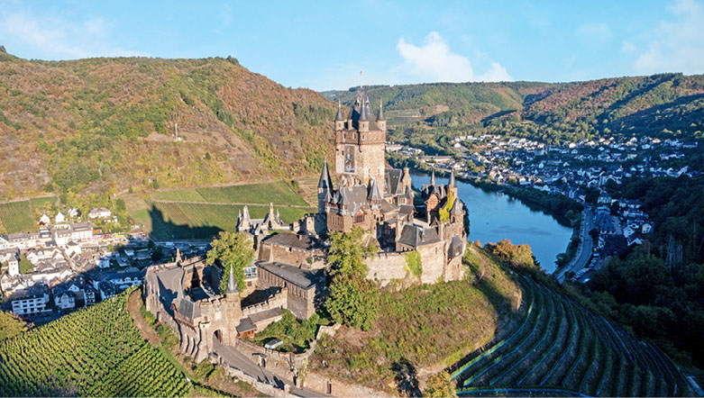Cochem Castle and the surrounding town, green fields and the Rhine River