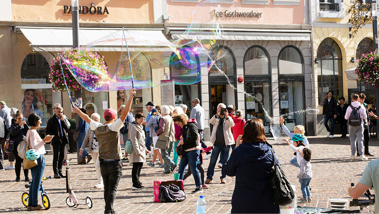 Street performers and crowd gathering in Trier, Germany