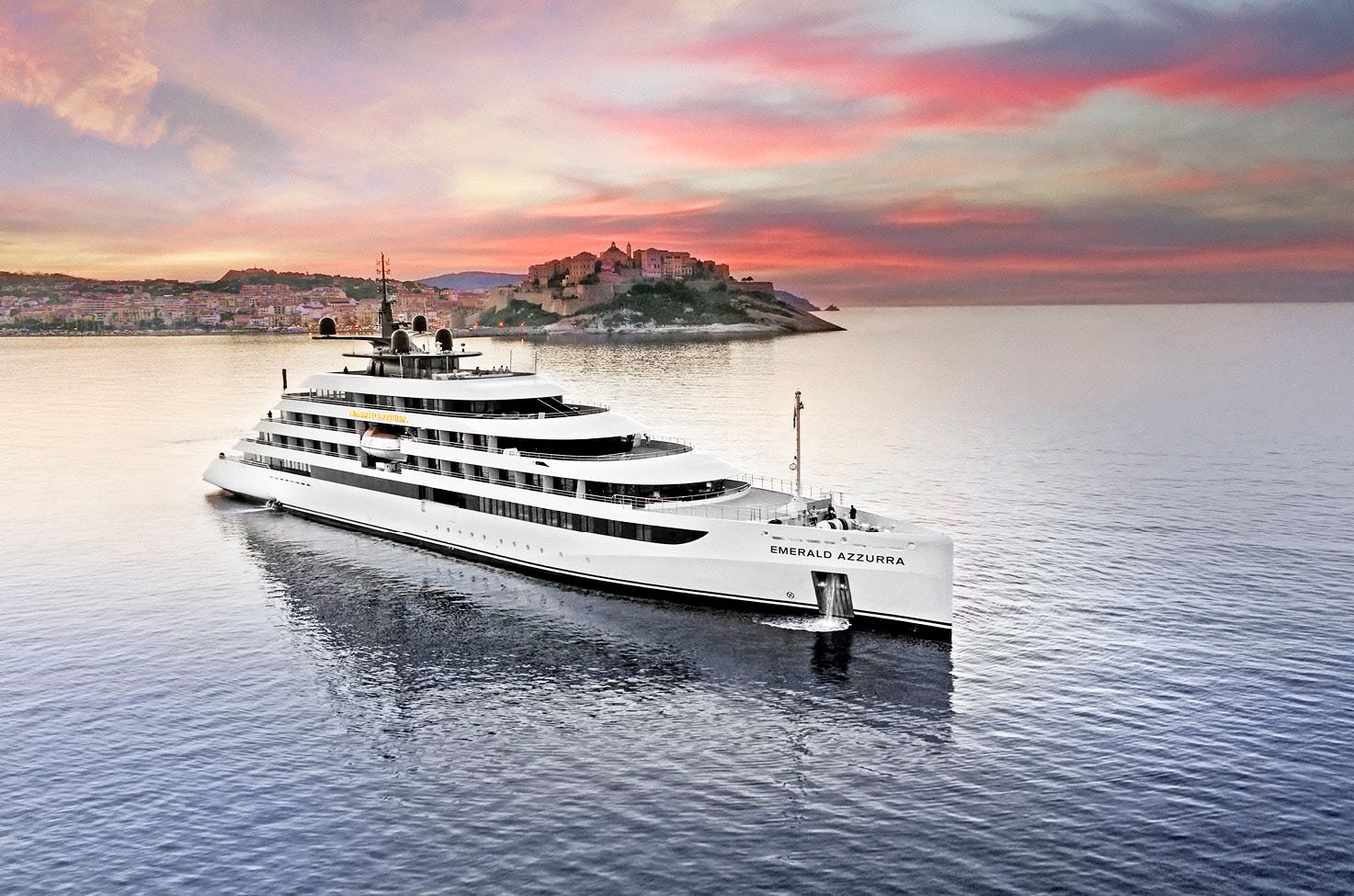 A luxury yacht cruise anchored in Calvi, Corsica, set against a dramatic red sky at sunset