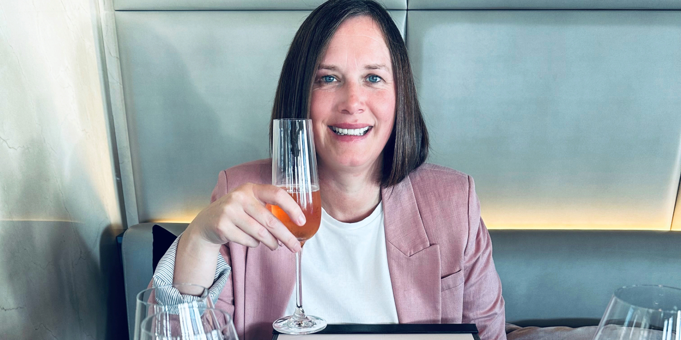 A women enjoys a beverage on board a luxury yacht cruise